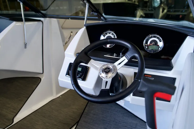 Slide: The Image of 2026 Four Winns H1 boat dashboard with steering wheel and gauges. - 7