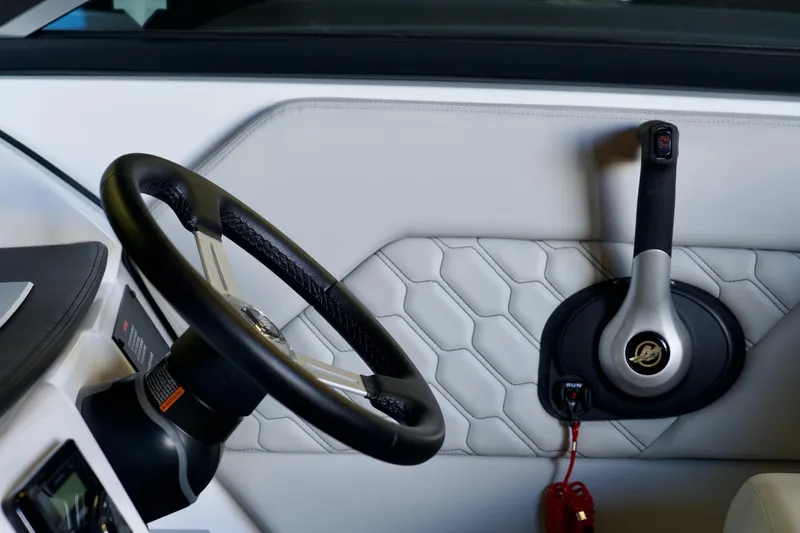 Slide: The Image of 2026 Four Winns H1 boat interior with steering wheel and throttle control. - 8