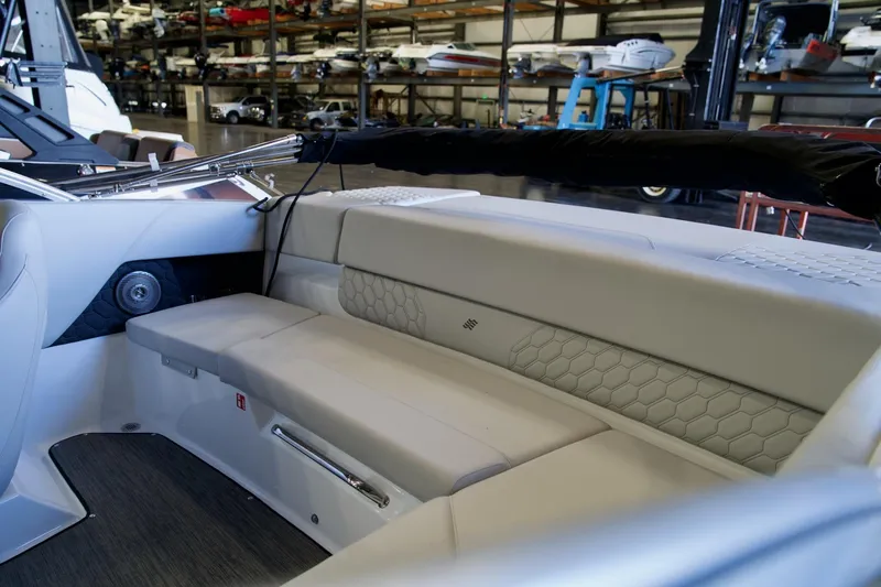 Slide: The Image of 2026 Four Winns H1 boat interior with sleek seating and modern design in a showroom. - 9