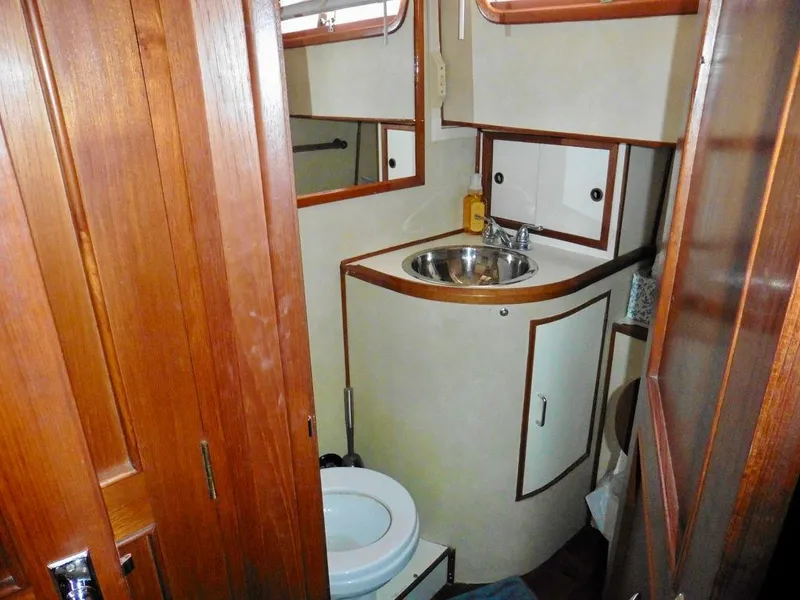 Slide: The Image of 1984 Ocean Alexander 38 Double Cabin bathroom with wooden accents and compact design. - 10