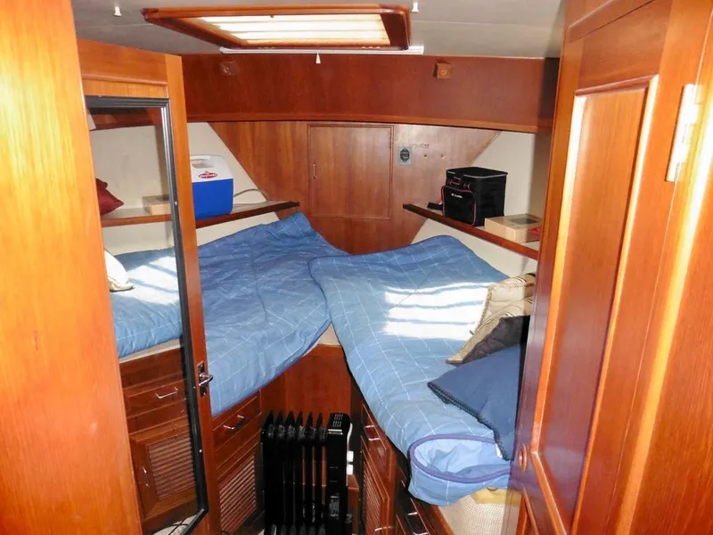 Slide: The Image of 1984 Ocean Alexander 38 Double Cabin interior with twin beds and wooden cabinetry. - 13