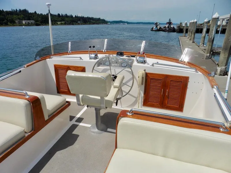 Slide: The Image of 1984 Ocean Alexander 38 Double Cabin boat interior with helm, wooden accents, and waterfront view. - 5