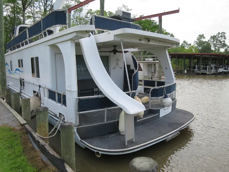 Slide: The Image of 1998 Monticello River Yacht Houseboat docked with slide and upper deck. - 1