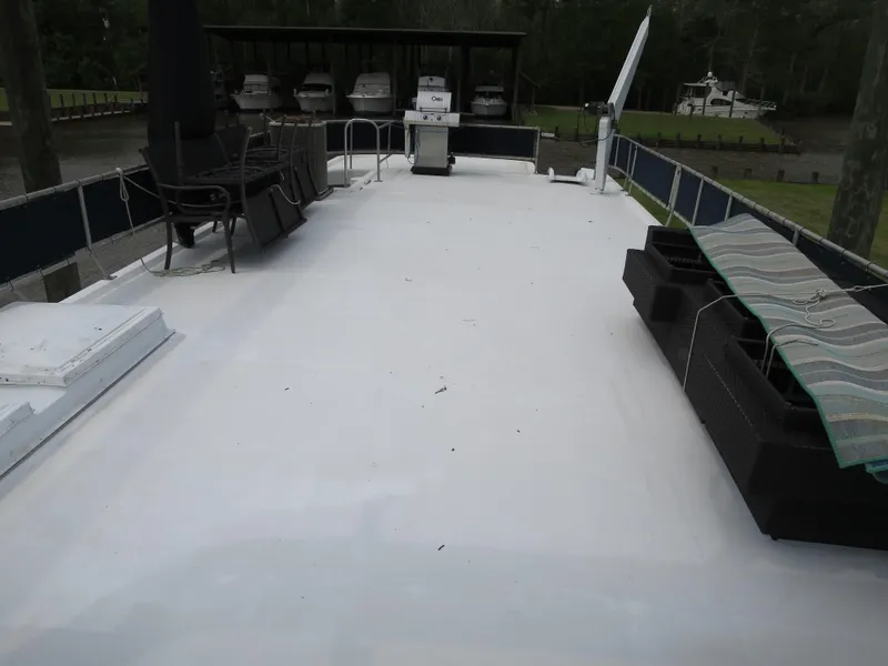 Slide: The Image of 1998 Monticello River Yacht Houseboat deck with outdoor seating and dining area. - 10