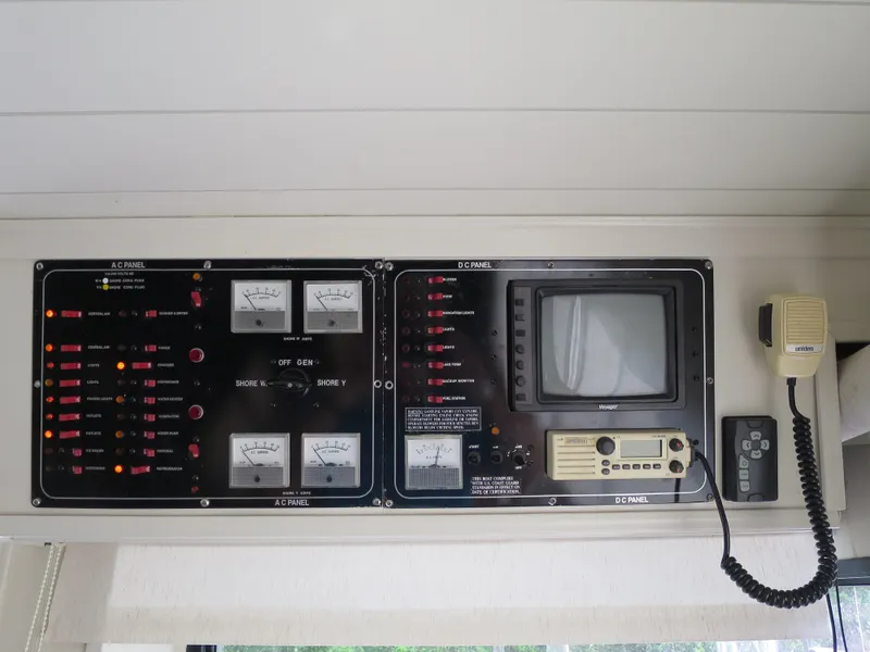 Slide: The Image of Control panel of a 1998 Monticello River Yacht Houseboat with gauges and communication equipment. - 12