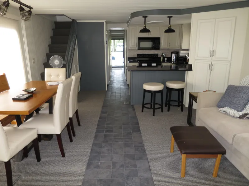 Slide: The Image of Interior of a 1998 Monticello River Yacht Houseboat with modern kitchen and dining area. - 15