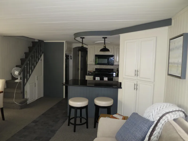 Slide: The Image of 1998 Monticello River Yacht Houseboat interior with modern kitchen and cozy living area. - 16