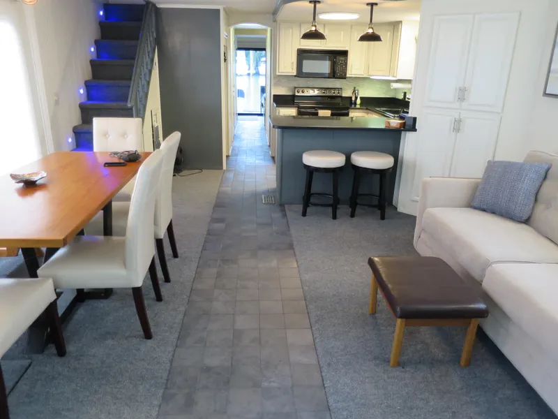 Slide: The Image of 1998 Monticello River Yacht Houseboat interior with modern kitchen, dining area, and cozy living space. - 2