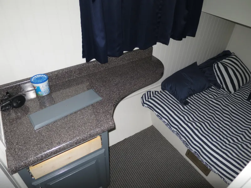 Slide: The Image of 1998 Monticello River Yacht Houseboat interior with bed and countertop. - 24