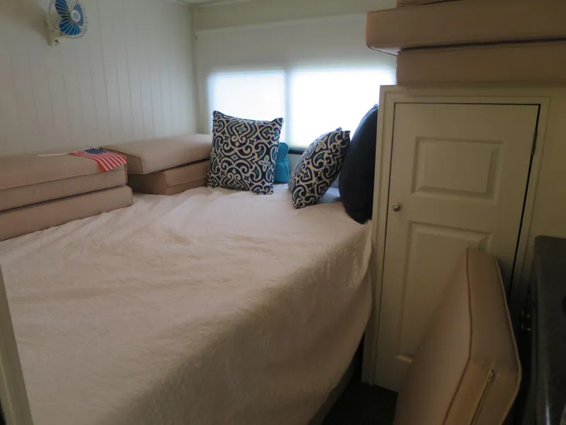 Slide: The Image of Cozy bedroom in 1998 Monticello River Yacht Houseboat with decorative pillows and storage. - 25