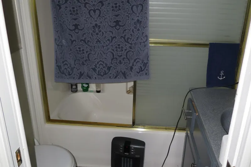 Slide: The Image of Bathroom in 1998 Monticello River Yacht Houseboat with shower, toilet, and heater. - 27