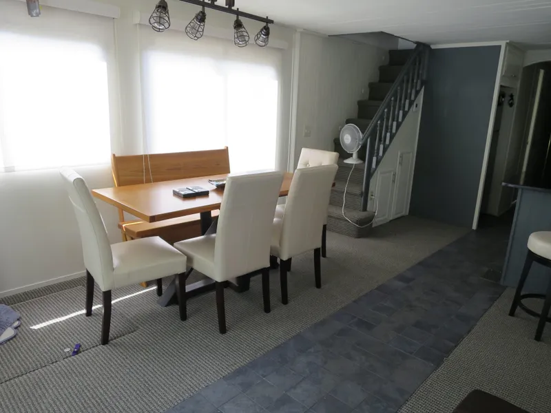 Slide: The Image of Dining area inside a 1998 Monticello River Yacht Houseboat with modern furniture. - 5