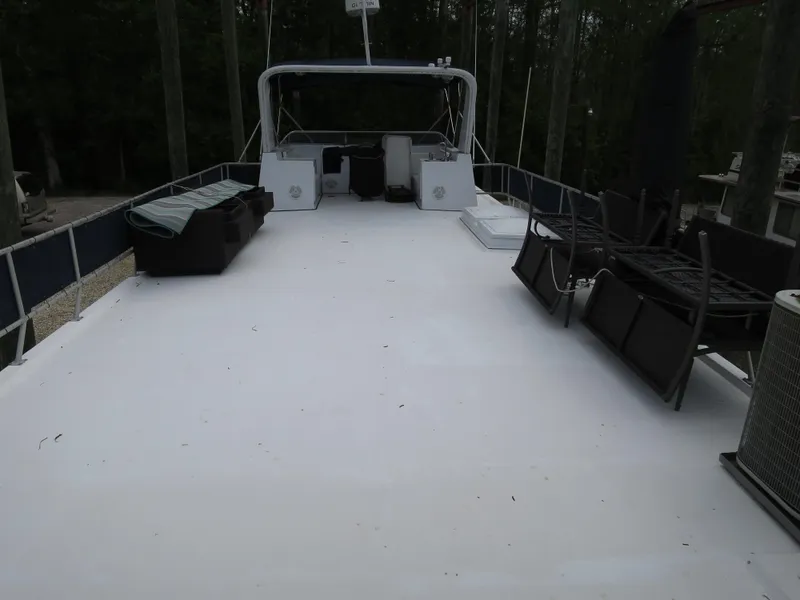 Slide: The Image of 1998 Monticello River Yacht Houseboat upper deck with seating and helm station. - 9