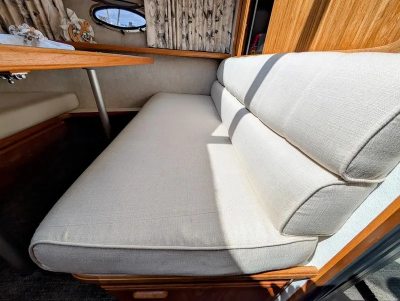 Slide: The Image of Interior seating of 1991 Carver 430 Cockpit Motor Yacht with beige cushions. - 19