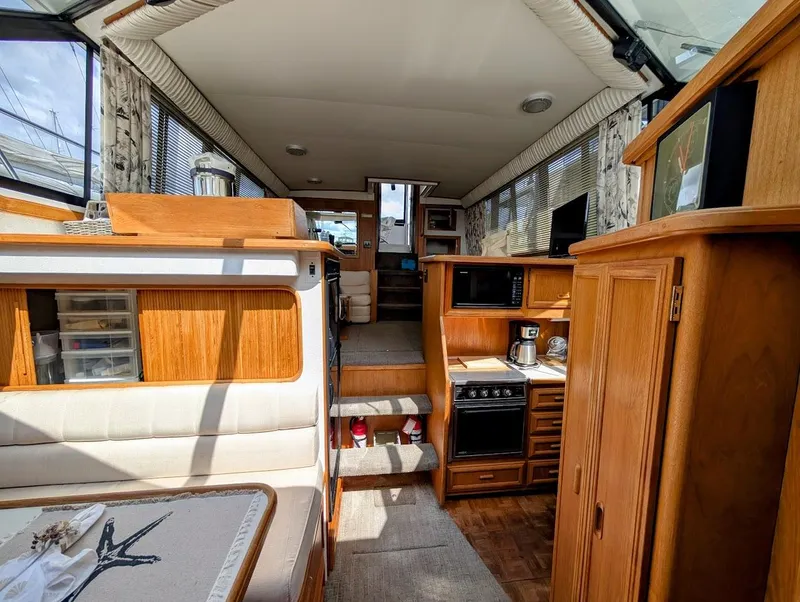 Slide: The Image of Interior of 1991 Carver 430 Cockpit Motor Yacht with wood cabinetry and modern amenities. - 20