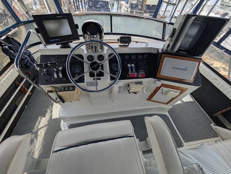 Slide: The Image of 1991 Carver 430 Cockpit Motor Yacht helm with Garmin navigation and control instruments. - 35