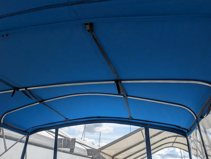 Slide: The Image of Blue canopy of a 1991 Carver 430 Cockpit Motor Yacht, with metal supports. - 38