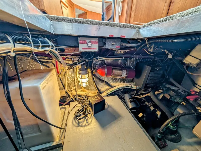Slide: The Image of Engine room of 1991 Carver 430 Cockpit Motor Yacht with wiring and fire extinguisher. - 39