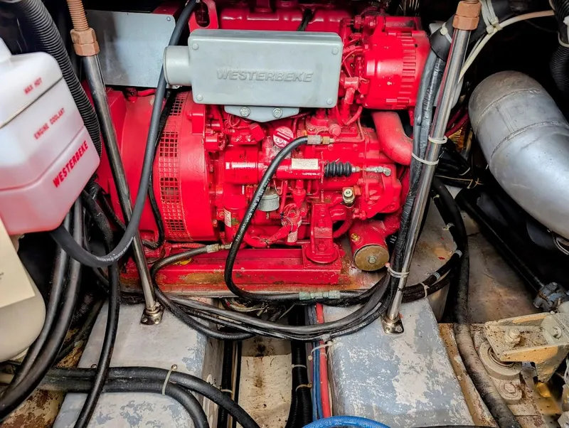 Slide: The Image of Engine room of 1991 Carver 430 Cockpit Motor Yacht with red Westerbeke generator. - 41