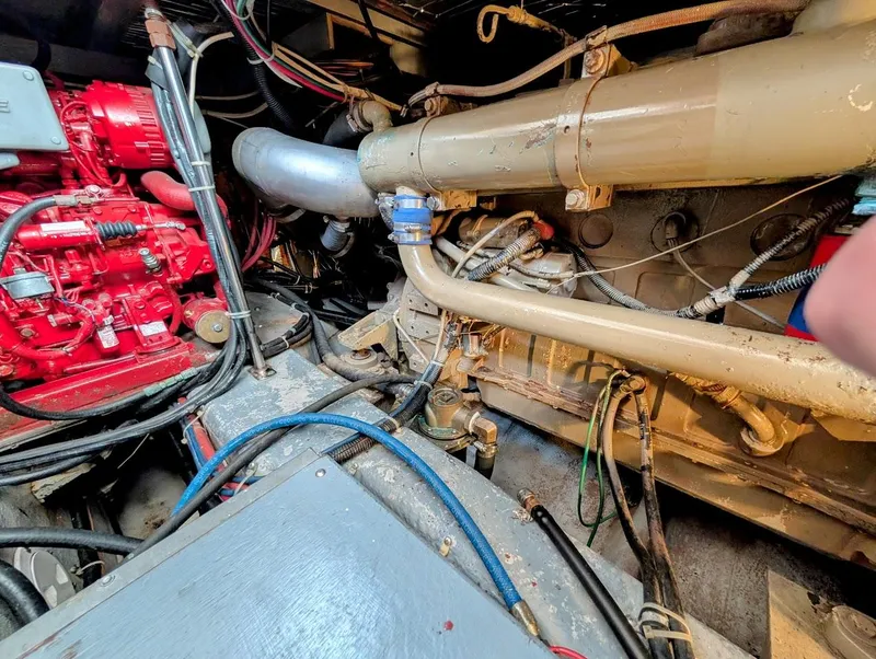 Slide: The Image of Engine room of a 1991 Carver 430 Cockpit Motor Yacht, showcasing mechanical components and wiring. - 42