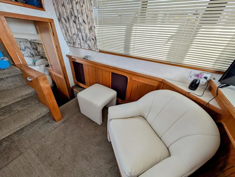 Slide: The Image of Interior of 1991 Carver 430 Cockpit Motor Yacht with seating and wooden accents. - 14