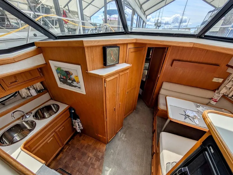 Slide: The Image of Interior of 1991 Carver 430 Cockpit Motor Yacht with kitchen and dining area. - 16