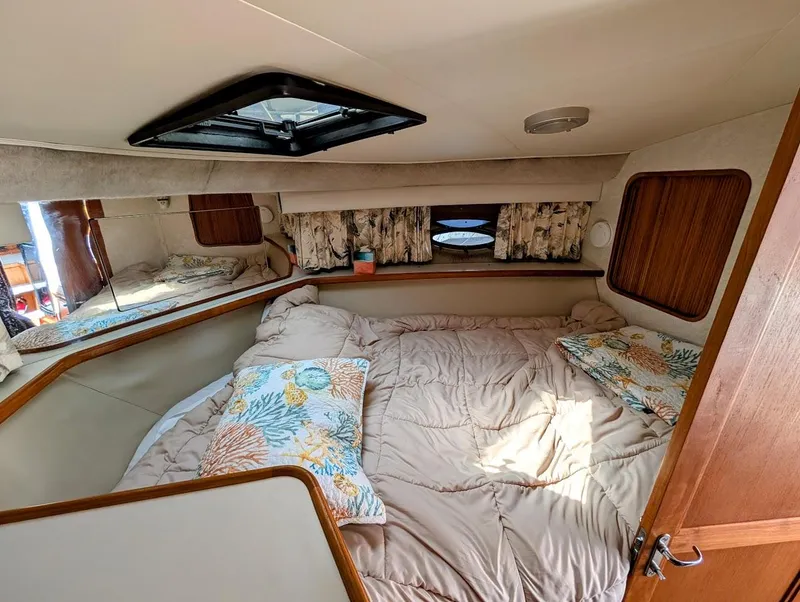 Slide: The Image of Cozy bedroom interior of 1991 Carver 430 Cockpit Motor Yacht with floral bedding. - 21