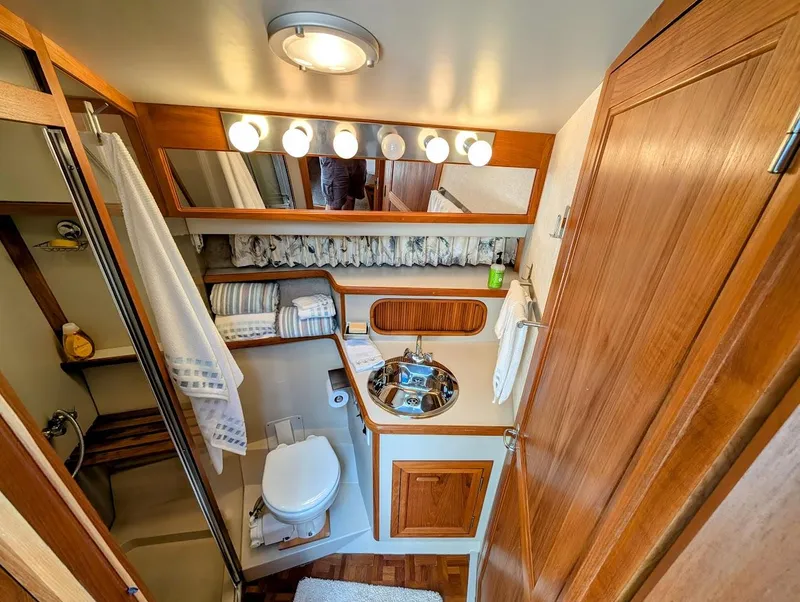 Slide: The Image of Luxurious bathroom in 1991 Carver 430 Cockpit Motor Yacht with wood accents and modern amenities. - 22