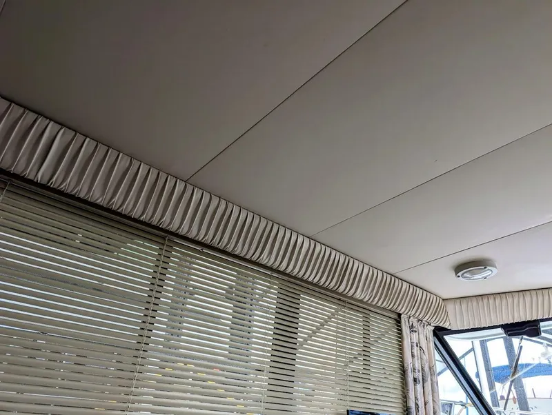 Slide: The Image of Interior view of 1991 Carver 430 Cockpit Motor Yacht with blinds and ceiling details. - 32