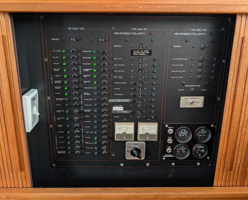 Slide: The Image of Control panel of a 1991 Carver 430 Cockpit Motor Yacht with various switches and gauges. - 43