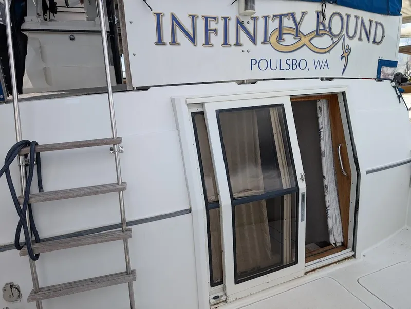 Slide: The Image of 1991 Carver 430 Cockpit Motor Yacht, "Infinity Bound," docked in Poulsbo, WA, with ladder and sliding door. - 5