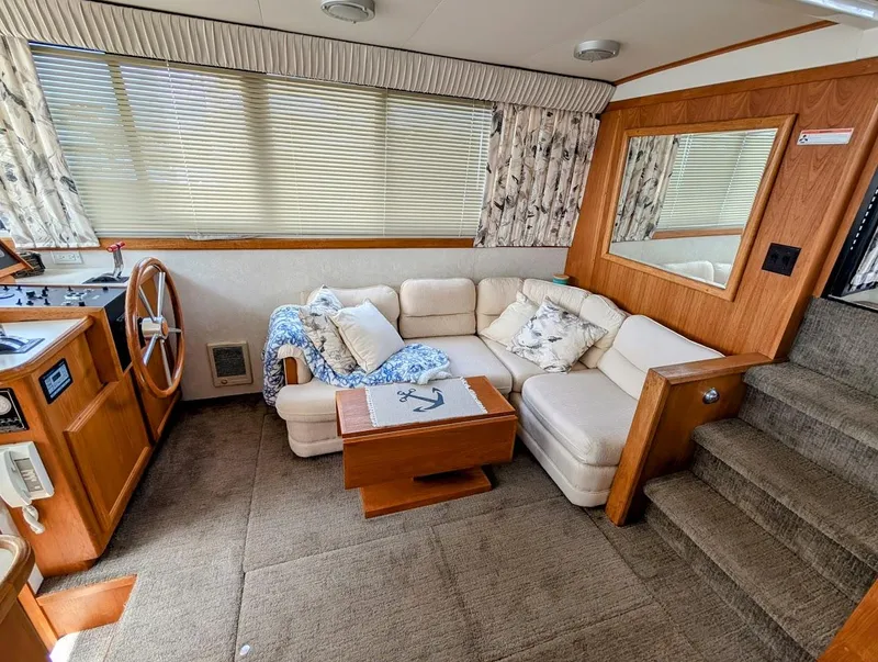 Slide: The Image of Interior of 1991 Carver 430 Cockpit Motor Yacht with cozy seating and nautical decor. - 8