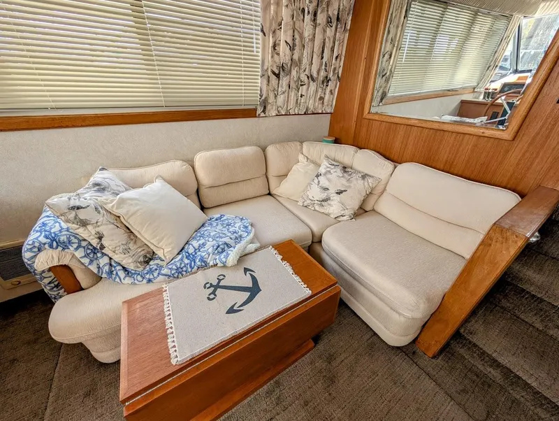 Slide: The Image of Cozy interior of 1991 Carver 430 Cockpit Motor Yacht with plush seating and nautical decor. - 9