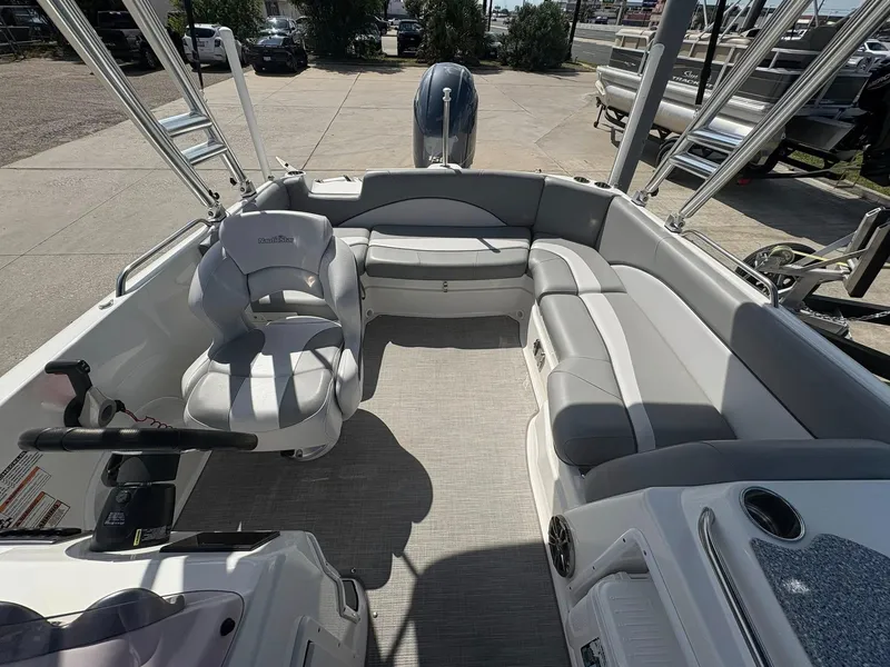 Slide: The Image of 2021 NauticStar 203 SC boat interior with gray seating and steering wheel. - 15