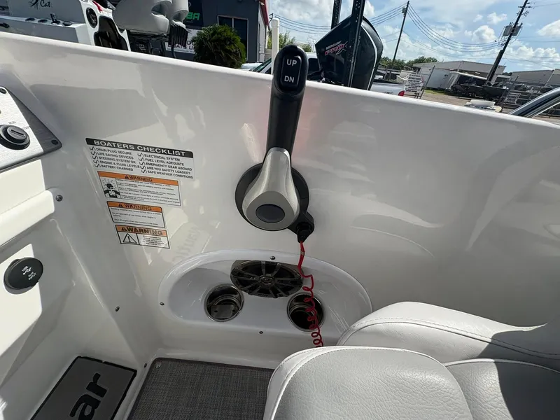 Slide: The Image of 2021 NauticStar 203 SC boat interior with control lever and safety checklist. - 6