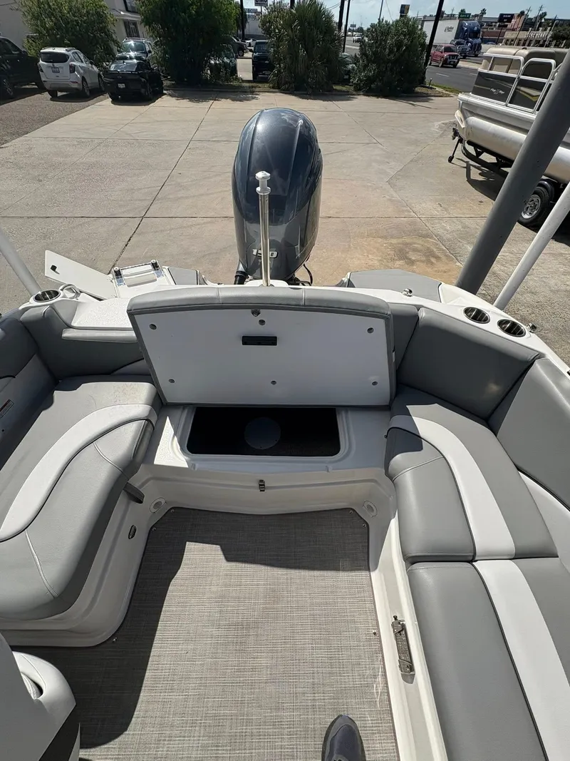 Slide: The Image of 2021 NauticStar 203 SC boat interior with open storage compartment and seating. - 9