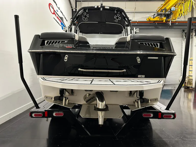 Slide: The Image of 2021 Moomba Kaiyen boat rear view in a showroom, showcasing sleek design and features. - 4