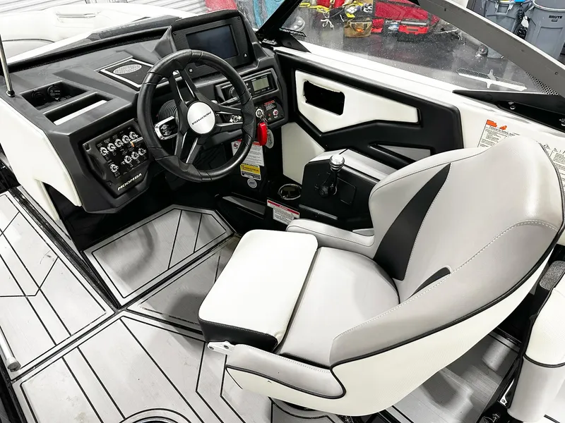 Slide: The Image of 2021 Moomba Kaiyen boat interior with steering wheel and captain's seat. - 7
