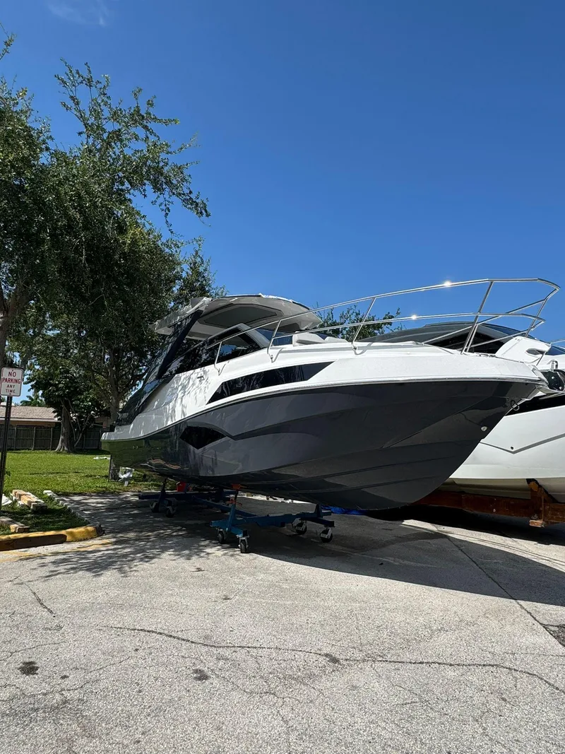 The Image of 2025 NX Boats NX340 yacht on display under clear blue sky. - 1