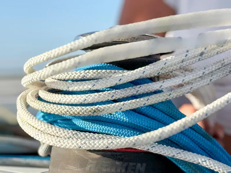 Slide: The Image of 2017 Lagoon 42 catamaran deck with netting, sailing on calm waters under clear skies. - 14