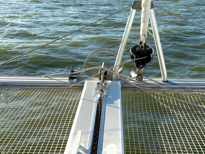 Slide: The Image of 2017 Lagoon 42 catamaran cockpit with steering wheel, marina view, and clear blue sky. - 15