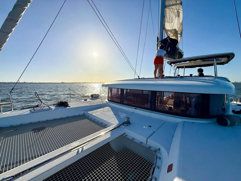 Slide: The Image of Sailing Lagoon 42 catamaran on open water under clear blue sky, 2017 model. - 2