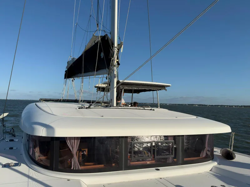 Slide: The Image of 2017 Lagoon 42 catamaran sailing on open sea under clear blue sky. - 3