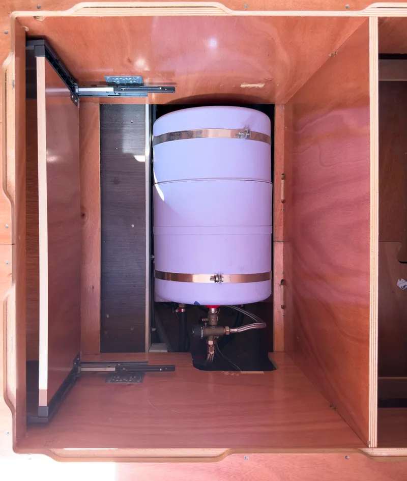 Slide: The Image of Plumbing system inside a 2017 Lagoon 42 boat, featuring hoses and valves. - 39