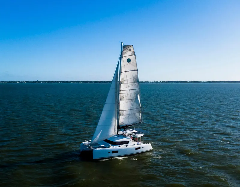 Slide: The Image of Deck of 2017 Lagoon 42 catamaran with rigging and netting over water. - 9
