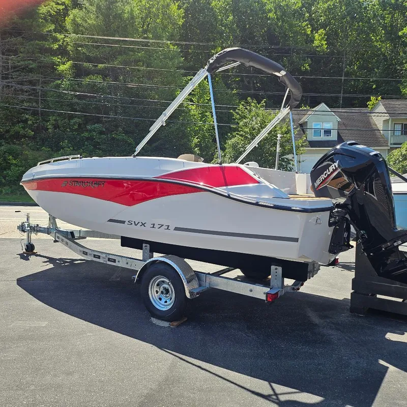 Slide: The Image of 2026 Starcraft SVX 171 OB boat on trailer, parked outdoors. - 15