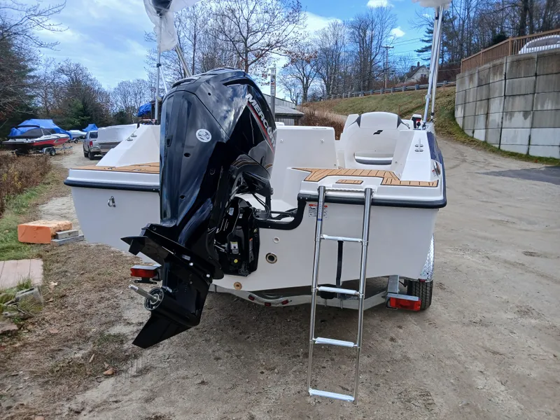 Slide: The Image of 2026 Starcraft SVX 171 OB boat with Mercury outboard motor and ladder, parked outdoors. - 4