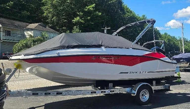 Slide: The Image of 2026 Starcraft SVX 171 OB boat on trailer, covered, parked outdoors. - 5