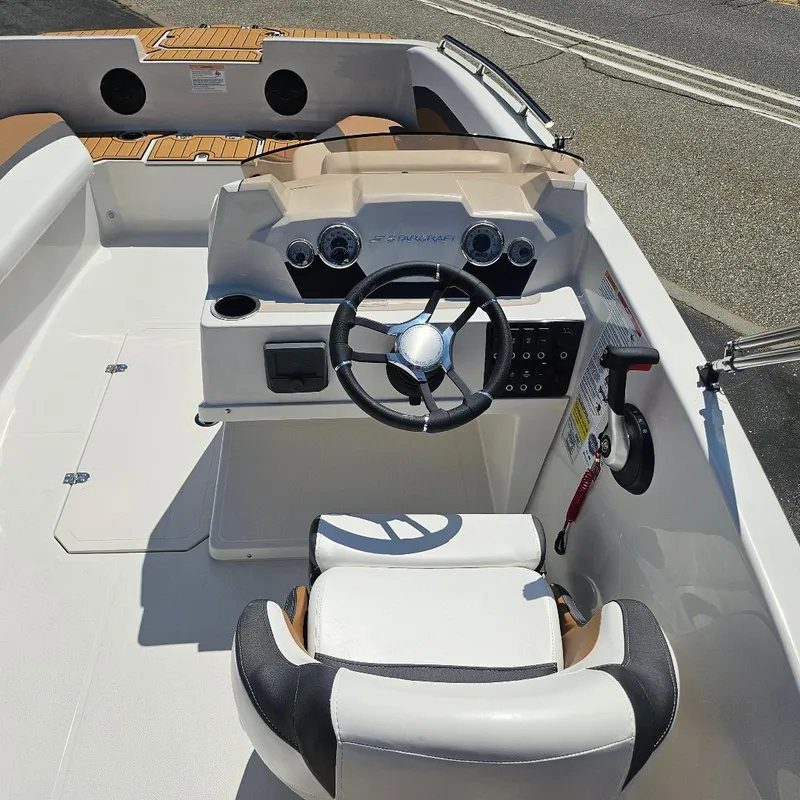 Slide: The Image of 2026 Starcraft SVX 171 OB boat cockpit with steering wheel and seating. - 8