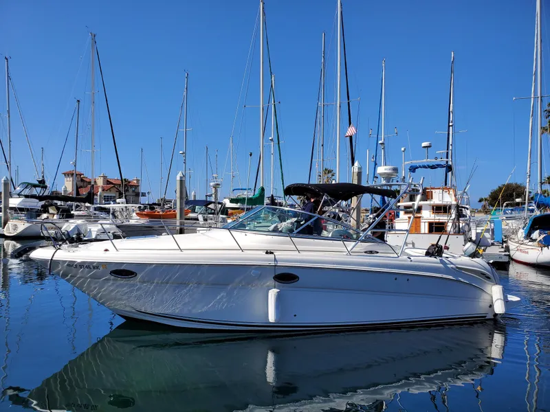 Slide: The Image of 2007 Sea Ray 290 Amberjack boat docked in a marina with sailboats. - 2